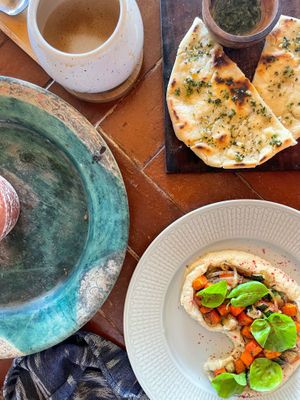 Oat milk flat white (top left), flat bread with herb-garlic oil (top right), and caulini   at Pituq Cafe in 