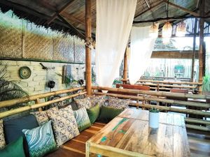Wooden gazeebos with fluffy cushions. at Pituq Cafe in 