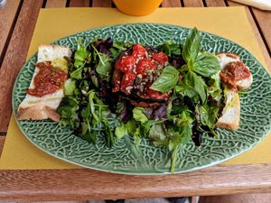 Eggplant with toppings, greenery, and a little bread at Fiumefreddo Bio in Venice