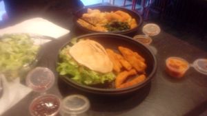 Thai curry and jerk felafel burger with various tasty sauces.  at Marees Sauces and Food in London