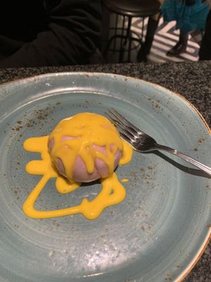 Steamed bun with taro inside and mango-vanilla sauce on it at LeDu Happy Dumplings & Noodle in Munich