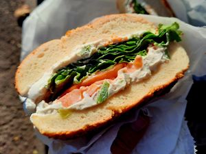 Onion bagel with veggie tofu spread, lettuce, and tomato at Tompkins Square Bagels in New York City