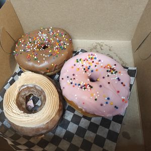 Pictured bottom, clockwise: apple cider cake,  chocolate dip, homer at Daddy O Doughnuts in Mississauga
