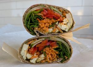 sprouted grain wrap with grilled tofu, red cabbage, cucumber, bell pepper, carrot, spinach, and pesto sauce at Roots Juice Bar - Churn Creek in Redding