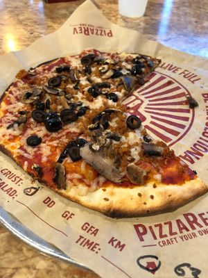 Vegan pizza w/ cheese, sausage, mushrooms, and black olives  at PizzaRev in Sioux Falls