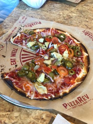 Spicing it up with jalapeño onions and artichokes with Vegan cheese  at PizzaRev in Sioux Falls