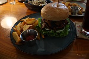 Bulgogi burger with a side of small potato wedges  at And 유 (Yu) Cafe in Jeju