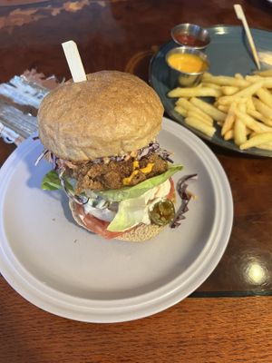 Vegan “chicken” burger served with wedges and vegan “cheddar” dip 🌱🍔 Hamburger buns are from the local bakery called RnR.  at And 유 (Yu) Cafe in Jeju