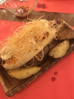 Delicious and slightly spicy (upon request) hot dog with mediocre potatoes. at La Tia Carlota in Madrid