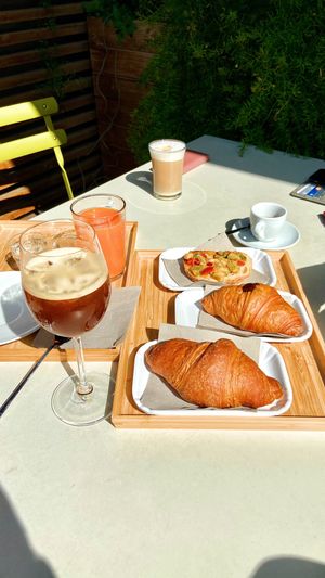Croissants, avo toast, juice, iced coffe, soy milk  at Bios Cafe in Rimini