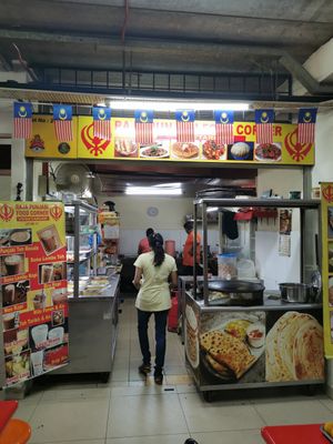 Tables in front of the restaurant in the food court at Raja Punjabi - Food Stall in Kuala Lumpur