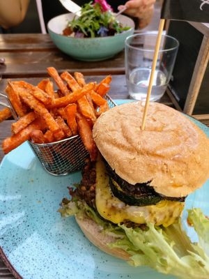 "Der Italiener" ("The Italian") burger with grilled veggies and vegan cheese, comes with sweet potatoe fries and ketchup/vegan mayo. at Vrohstoff in Wurzburg