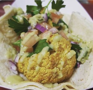 Vegan veggie taco - tumeric roasted cauliflower with fresh cilantro, red onion, tomato, jalapeño crema at Moonlight Cafe in Brewster
