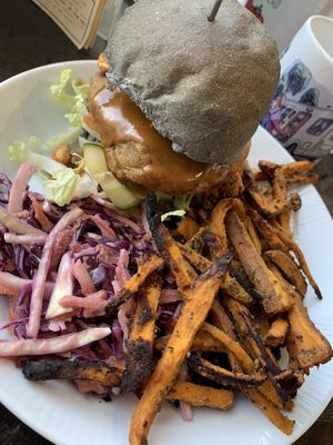 Spicy satay burger- lovely peanuty flavour and crunchy texture, coleslaw and sweet potato fries to finish it off:))  at Be The Change - Bake a Difference in Worcester