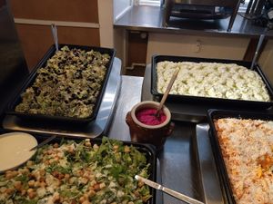 raw broccoli with black raisins and herb, hummus, coconut gratings with carrot shreds, boiled sweet potatoes with salad and beetroot paste at RizRaz - Kannikestraede in Copenhagen