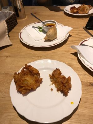 Half eaten onion bhajis and vegetable Somoza  at Nataraj - Harajuku Omotesando in Tokyo