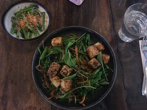 Crispy fried tofu with homemade noodles and vegetables (vegan version), coconut spinach at Pobrecito in Helsinki