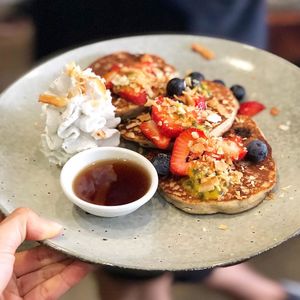 Gluten free pancakes, with a side of dairy, sugar, gluten free, coconut whipped cream and maple syrup. at Pure Wholefoods in Manly