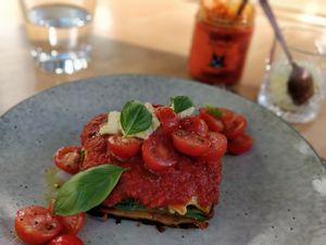 Vegan lasagne with vegan parmesan and chilli oil in the background at Mark & Vinny's Spaghetti & Spritz in Surry Hills
