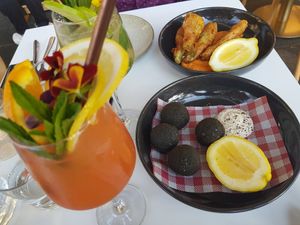 Black arancini with brown mushroom, vegan Parmigiani and cashew aioli plus zucchini flowers with soy ricotta at Mark & Vinny's Spaghetti & Spritz in Surry Hills