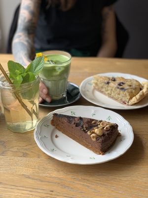 Frangipane and chocolate mousse hazelnut cake, with the house iced tea and iced matcha latte  at Blackbird in Bruges