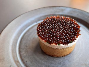 Crumpet with ricotta, chives, and black garlic caviar at Ark in Copenhagen