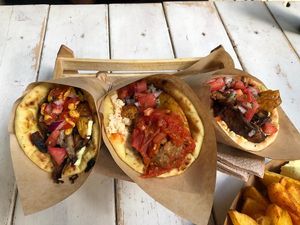 Yellow, red and kebab pitas, and potatoes at Cookoomela Grill in Athens