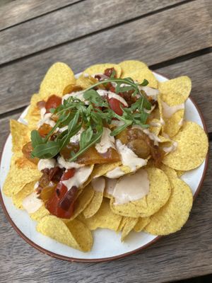 Small Nacho Republica 🌱 
Vegan
Nachos - Nachos - roasted peppers - red onion - tomato - tahini dressing - chili oil
€11.00  at De Republiek in Bruges