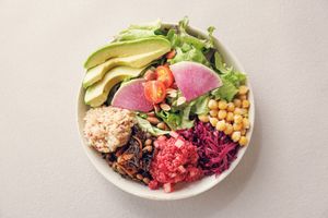 Popular salad bowl — leafy greens topped with 3 veggie deli, bean deli, avocado, ancient grain brown rice & crushed almonds. Fully vegan, gluten-free & bursting with natural color. at L for You in Tokyo