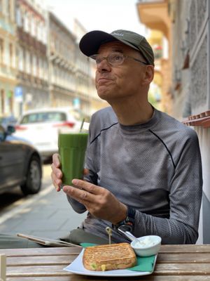 Awokado tosty, green smoothie with a straw made of corn. at Vegano Cafe in Krakow