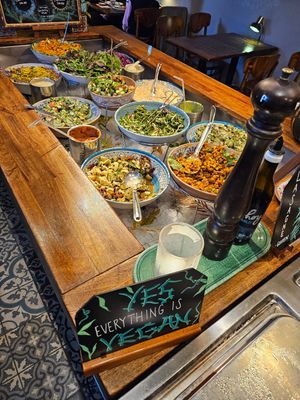Salad bar with a sign above declaring what you see at Hermans in Stockholm