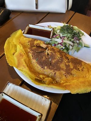A crispy pancake filled with mushrooms and vegetables and tofu plus a salad  at Good Morning Vietnam Vegan in Berlin