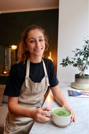 Kat is a pro of making Matcha latte!  at Matcha Bar - Helgolandsgade in Copenhagen