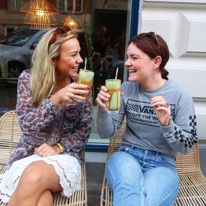 Girls enjoying their Iced Matcha latte w. Salty caramel  at Matcha Bar - Helgolandsgade in Copenhagen