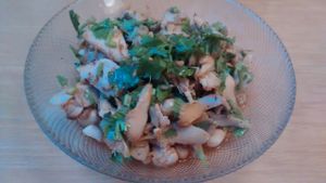 Sliced hedgehog mushrooms, marinated in chili and Sichuan pepper oil, coriander, and roasted garlic, served with peanuts and spring onions. at Lao Wai in Stockholm