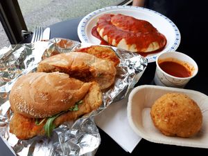 Chicken parmigiana sandwich, panzarotto panzarotti (w/ cashew mozzarella, sausage, mushrooms, and roasted red peppers), and an arancini ball (rice, cheese, and vegan meat battered and baked) with tomato dipping sauce. at The Vegitaliano in Vaughan