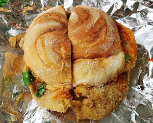 Chick'n parmesan sandwich with a side of marinara sauce at The Vegitaliano in Vaughan