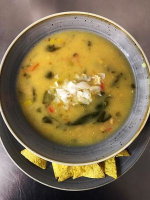 Vegan chickpea soup with coconut milk and corn chips. at Bunker in Murska Sobota