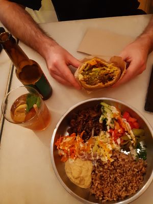 falafel pita to the top and seitan shawarma bowl to the bottom with homemade iced tea and local ipa at Falafeleria - Sta Barbara in Madrid