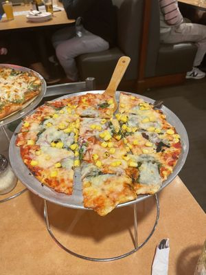 St Louis style pizza with Follow Your Heart mozzarella, red onions, spinach, and corn.   at Waldo Pizza in Kansas City