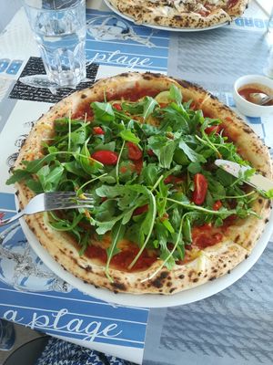 Pizza with vegan chesse, zucchini, peppers and plenty of arugula at Pizzeria Fuoriseria in Izola