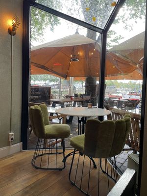 Cozy seating area inside with harbor view  at Healthful in Rotterdam