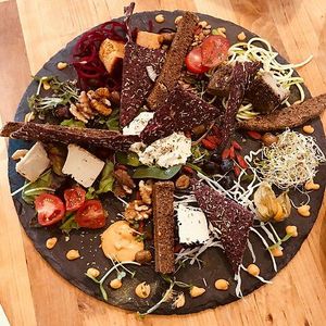 Cheese plate with mozarella, black pepper cheese, almond cheese etc at The Raw Kitchen Malmö in Malmo