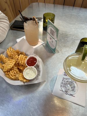 Waffle fries w/ vegan ranch and ketchup. Drinks are a guava fizz w/ vodka and a mouth of Sundays    at Bang Up To The Elephant in Denver
