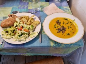Ølands bread, salad, roasted potatoes and soup with basil oil and roasted pumpkin seeds at Kaernehuset Vegetarian Club in Odense