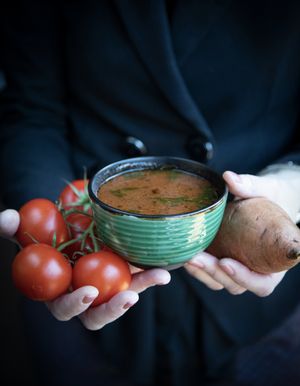 Roasted Tomato with sweet potato, red onion, tomatoes and garlic. Topped with basel oil.  at Kaernehuset Vegetarian Club in Odense