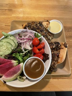 Vegan cheesesteak with a side salad (top dressing is vegan orange and bottom is vegan black garlic)   at 98 Center Moab in Moab