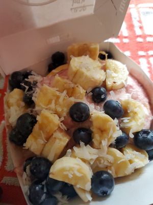tropical bliss with berry frosting, banana, blueberries and shredded coconut at Cinnaholic in San Jose