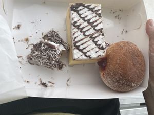 Vanilla slice, jam donut and our mostly devoured lamington   at Flour of Life Bakery in Helensvale