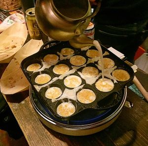 Making takoyaki  at Self Takoyaki Bar IDUCO in Osaka